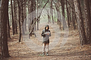 Hiker woman with tablet walking outdoor