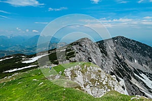 Petzen - Hiker woman on top of Feistritzer Spitze (Hochpetzen), Carinthia, border Austria Slovenia. Alpine meadow photo