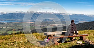 HIker woman on top of the hill looking on High Tatras mountains, Slovakia