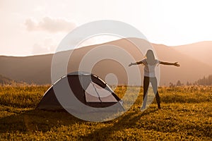 Hiker woman on top of mountain with open hands