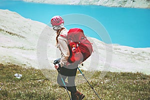 Hiker woman traveling at blue lake mountains