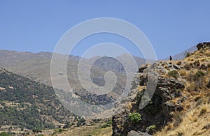 Hiker woman walking along Poqueira Gorge, Granada, Spain