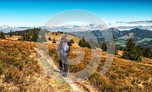 Hiker woman walking on mountain ridge in Great Fatra mountains in Slovakia