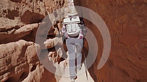 A Hiker Woman Walks Between The Rocks Of The Grand Canyon