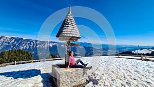 Dreilaendereck - Hiker woman at wooden monument at Dreilaendereck, Karawanks, Carinthia, Austria photo