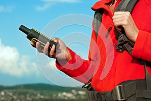 Hiker young woman holding in her hand GPS