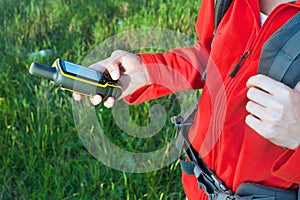 Hiker young woman holding in her hand GPS