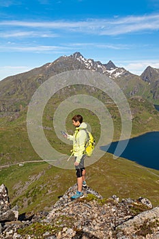 Hiker young woman holding in her hand GPS