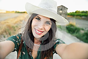 Hiker young woman taking a selfie photograph outdoors