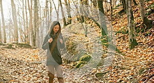 Hiker young woman walking in autumn forest
