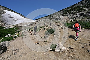 Hikers ascend Saint Mary's Glacier Trail in Arapaho National Forest, Colorado.