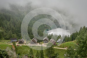 Hikers in the austrian alps walk on mountain hiking trails in the woods around the lakes