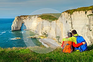 Hikers with backpack, enjoying the ocean, Etretat, Normandy, France