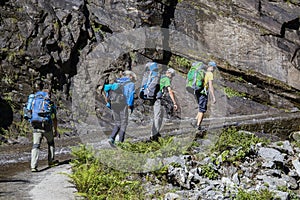 Hikers with backpack on trekking trail in Himalayan mountains. Nepal