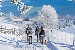 Hikers Beautiful winter scenery in a Romanian village