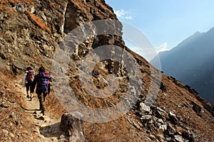 Hikers in the central part of one of the deepest ravines of the world, Tiger Leaping Gorge in Yunnan, Southern China