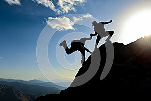 Hikers climbing on mountain. Help, risk, support, assistance