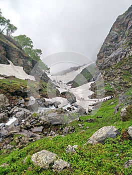 Hikers Climbing though slippery glacier patch in an Indian Himalayan Mountain Valley