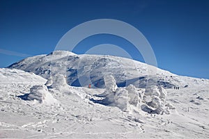 Hikers climbing to snowy Babia Gora summit Carpathians Poland photo