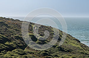 Hikers by ocean near Hartland Quay in Devon photo