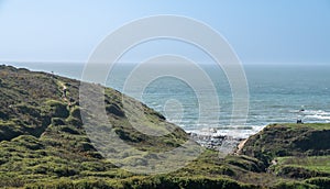 Hikers by ocean near Hartland Quay in Devon photo