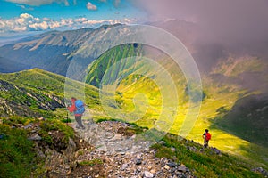 Hikers with colorful backpacks in Fagaras mountains, Carpathians,Transylvania, Romania