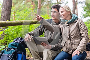 Hikers determinating their position by GPS on tablet PC