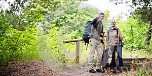 Hikers with dog in forest