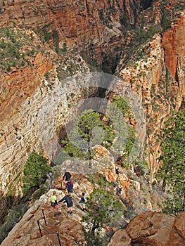 Hikers on double cliff trail to the top of landmark Angeles Landing, Zion National Park, USA