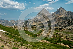 Hikers Dwarfed By The Surrounding Tetons