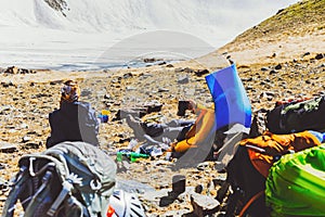 Hikers enjoy tea at the camping. Group friends traveler enjoying views in mountains