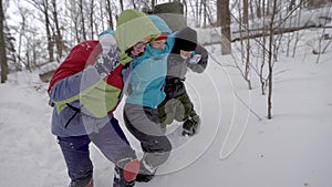 Hikers Helping Injured Friend to Walk in Snow