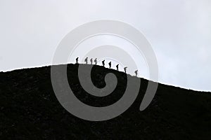 Hikers on hillside in black and white