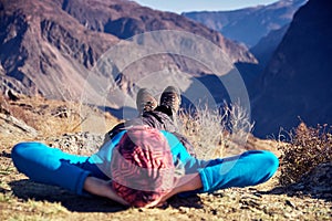 Hikers lie down taking resting after long walk at top of mountain. Altai