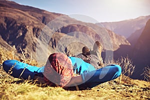 Hikers lie down taking resting after long walk at top of mountain. Altai