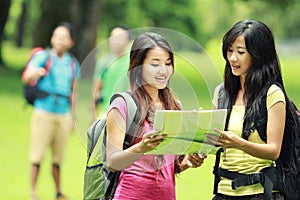 Hikers Looking The Map In Countryside