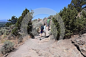 Hikers on Misery Ridge Trail in Smith Rock State Park, Oregon.