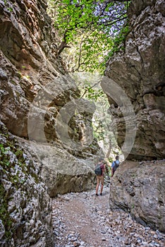 Hikers in a narrow trail of Imbros gorge, Crete Greece