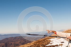 Hikers pointing with hiking pole and hand