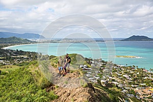 Hikers posing for a portrait with the view of Lanikai from a top