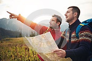 Hikers reading a trail map while trekking in the hills