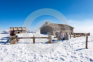 Hikers Relaxing in front of an Old Farmhouse on Lessinia Plateau Veneto Italy