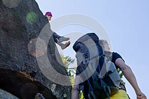 Hikers rest on the stone while hiking