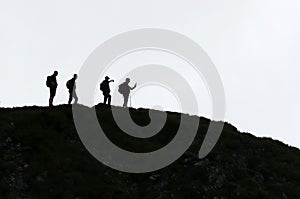 Hikers on ridge in black and white