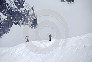 Hikers on the snow at the Aiguille du Midi mountain photo