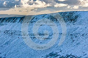 Hikers on a snow covered mountain ridge (Brecon Beacons, Wales