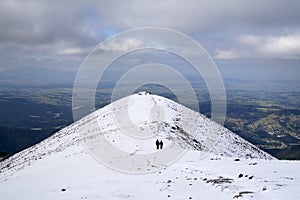 Hikers on snowy mountain