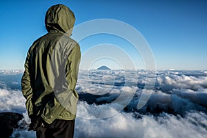 Hikers on the summit of Mt. Kita at sunset, admiring Mt. Fuji in the distance