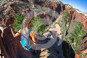 Hikers walk on the steep and dangerous trail named Angels Landin