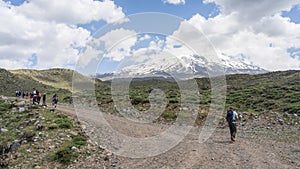 Hikers walking to the basecamp with snowy mountain summit in backdrop, Mount Ararat in Turkey